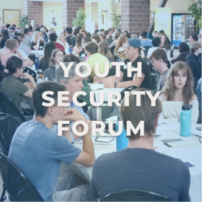 Young people sitting at tables conversing together. Image reads, "YOUTH SECURITY FORUM"